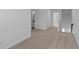 Hallway features neutral carpet and light walls with views into other rooms at 7070 Nine Penny Dr, Brownsburg, IN 46112