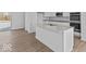 Modern kitchen with stainless steel appliances, white cabinets, and a spacious island at 7070 Nine Penny Dr, Brownsburg, IN 46112