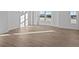Bright living room featuring large windows and luxury vinyl plank flooring at 7070 Nine Penny Dr, Brownsburg, IN 46112