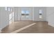 Spacious living area filled with natural light from multiple windows and luxury vinyl plank flooring at 7070 Nine Penny Dr, Brownsburg, IN 46112
