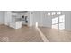 Modern kitchen with stainless steel appliances, white cabinets, and a spacious island at 7070 Nine Penny Dr, Brownsburg, IN 46112
