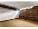 Unfinished basement with exposed brick and ductwork, perfect for customization at 735 Lexington Ave # 1, Indianapolis, IN 46203