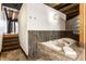 Relaxing bathroom with a tiled jacuzzi bathtub and a staircase at 735 Lexington Ave # 1, Indianapolis, IN 46203
