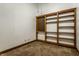 Bedroom interior featuring custom built-in wooden shelves, base molding and neutral carpet at 735 Lexington Ave # 1, Indianapolis, IN 46203