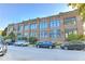 Exterior of a brick building with a parking lot and a variety of vehicles at 735 Lexington Ave # 1, Indianapolis, IN 46203