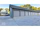 Exterior view of garages with multiple overhead doors and paved parking at 735 Lexington Ave # 1, Indianapolis, IN 46203
