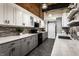 Modern kitchen featuring two-tone cabinets, stone backsplash, stainless steel appliances and an industrial style at 735 Lexington Ave # 1, Indianapolis, IN 46203