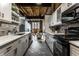 Modern kitchen with black appliances, two-tone cabinets and tiled floors that leads into the dining room at 735 Lexington Ave # 1, Indianapolis, IN 46203