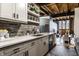 Kitchen featuring white quartz countertops, stainless appliances, floating shelves, and an open floor plan at 735 Lexington Ave # 1, Indianapolis, IN 46203