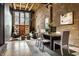 Stylish living room with exposed brick, hardwood floors, and large windows at 735 Lexington Ave # 1, Indianapolis, IN 46203