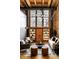Open concept living area with exposed brick, large windows, beamed ceilings, neutral furniture and stylish decor at 735 Lexington Ave # 1, Indianapolis, IN 46203