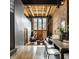 Spacious living room featuring hardwood floors, exposed brick, and tall ceilings at 735 Lexington Ave # 1, Indianapolis, IN 46203