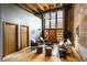 Bright, open living space with exposed brick, beamed ceilings, neutral furniture and large windows at 735 Lexington Ave # 1, Indianapolis, IN 46203