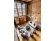 Bright living room with exposed brick, large windows, and stylish modern furniture at 735 Lexington Ave # 1, Indianapolis, IN 46203