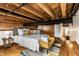 Large bedroom features hardwood floors, exposed beams, and stylish ensuite access at 735 Lexington Ave # 1, Indianapolis, IN 46203
