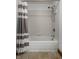 Close up view of a shower and tub with gray and white striped shower curtain at 735 Lexington Ave # 1, Indianapolis, IN 46203