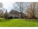 Aerial view showing a home with a deck and ample green space with trees surrounding the backyard at 7472 Windridge Way, Brownsburg, IN 46112