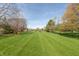 Spacious lawn lined with trees, offering plenty of room for outdoor activities and landscaping opportunities at 7472 Windridge Way, Brownsburg, IN 46112