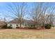 Expansive backyard with a well-maintained lawn and a charming deck, ideal for relaxation and entertainment at 7472 Windridge Way, Brownsburg, IN 46112