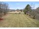 Expansive backyard featuring lush greenery and mature trees, perfect for outdoor activities at 7472 Windridge Way, Brownsburg, IN 46112