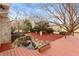 Backyard pond and deck, accentuated by a serene waterfall feature and lush landscaping at 7472 Windridge Way, Brownsburg, IN 46112