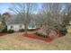 Aerial view of the backyard with trees, showing the back of the house with a deck at 7472 Windridge Way, Brownsburg, IN 46112