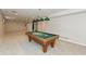 Finished basement with a pool table and hanging lights, creating a recreational space at 7472 Windridge Way, Brownsburg, IN 46112