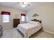 Cozy bedroom with patterned bedding, carpet, and natural light at 7472 Windridge Way, Brownsburg, IN 46112