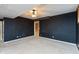 Spacious bedroom with a ceiling fan, neutral carpet, and contrasting black accent wall at 7472 Windridge Way, Brownsburg, IN 46112