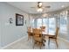 Bright dining area featuring a wood table set, chandelier, neutral walls and large windows at 7472 Windridge Way, Brownsburg, IN 46112