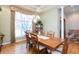 Formal dining room with hardwood floors, a chandelier, and large window view at 7472 Windridge Way, Brownsburg, IN 46112