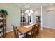 Elegant dining room featuring a large table, hardwood floors, and a stylish chandelier at 7472 Windridge Way, Brownsburg, IN 46112