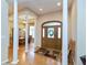 Elegant foyer with hardwood floors, decorative columns, and a view into the dining room at 7472 Windridge Way, Brownsburg, IN 46112