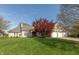 Charming brick home featuring a meticulously manicured lawn and vibrant landscaping, creating excellent curb appeal at 7472 Windridge Way, Brownsburg, IN 46112