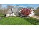 Well-maintained brick home with a lush green lawn, beautiful landscaping, and attached two-car garage at 7472 Windridge Way, Brownsburg, IN 46112