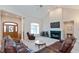 Bright living room with vaulted ceilings, a cozy fireplace, and comfortable leather furniture at 7472 Windridge Way, Brownsburg, IN 46112