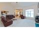 Bright and open living room with comfortable leather furniture, neutral colors, and great lighting at 7472 Windridge Way, Brownsburg, IN 46112