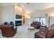 Spacious living room with a fireplace, high ceilings, and large windows at 7472 Windridge Way, Brownsburg, IN 46112