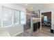 Modern walk-in shower with gray tile, a glass enclosure, and a rainfall shower head at 7472 Windridge Way, Brownsburg, IN 46112