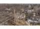 Spacious home with mature trees, large windows, and charming details set amongst a dense woodland environment at 8001 N Illinois St, Indianapolis, IN 46260