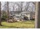 Expansive backyard featuring a patio with a fire pit, screened-in porch and a spacious deck off the second level at 8001 N Illinois St, Indianapolis, IN 46260