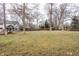 Expansive backyard featuring a large lawn area, mature trees, and views of the home's exterior at 8001 N Illinois St, Indianapolis, IN 46260