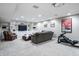 Finished basement with built-in shelving, media space and exercise equipment at 8001 N Illinois St, Indianapolis, IN 46260