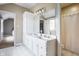 Bright bathroom with a double sink vanity and well-lit mirror at 8001 N Illinois St, Indianapolis, IN 46260