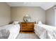 Comfortable bedroom with two twin beds, hardwood floors, and stylish decor at 8001 N Illinois St, Indianapolis, IN 46260