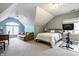 Upstairs bedroom with sloped ceiling, ceiling fan, and sitting area by a window at 8001 N Illinois St, Indianapolis, IN 46260