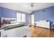 Stylish bedroom featuring hardwood floors, a large window, and a cozy bed at 8001 N Illinois St, Indianapolis, IN 46260
