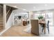 Open concept dining area leading to the kitchen and living room with hardwood floors at 8001 N Illinois St, Indianapolis, IN 46260