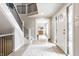 Inviting foyer with hardwood floors, staircase, and view into a bright and open living space at 8001 N Illinois St, Indianapolis, IN 46260