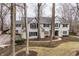 Charming home with a well-manicured front yard, mature trees, and classic architectural details at 8001 N Illinois St, Indianapolis, IN 46260